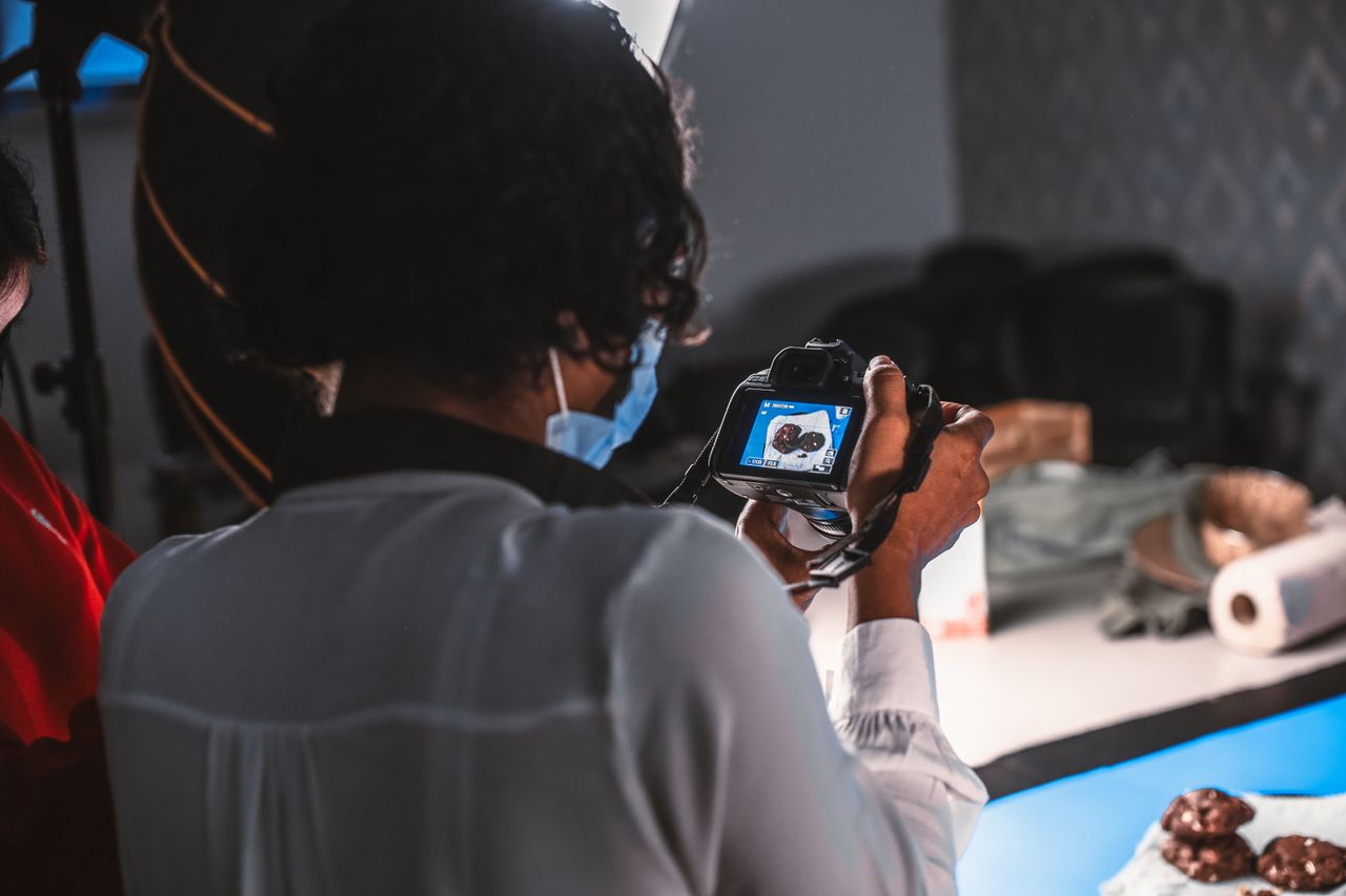 Photographer capturing a dessert setup with studio lighting.